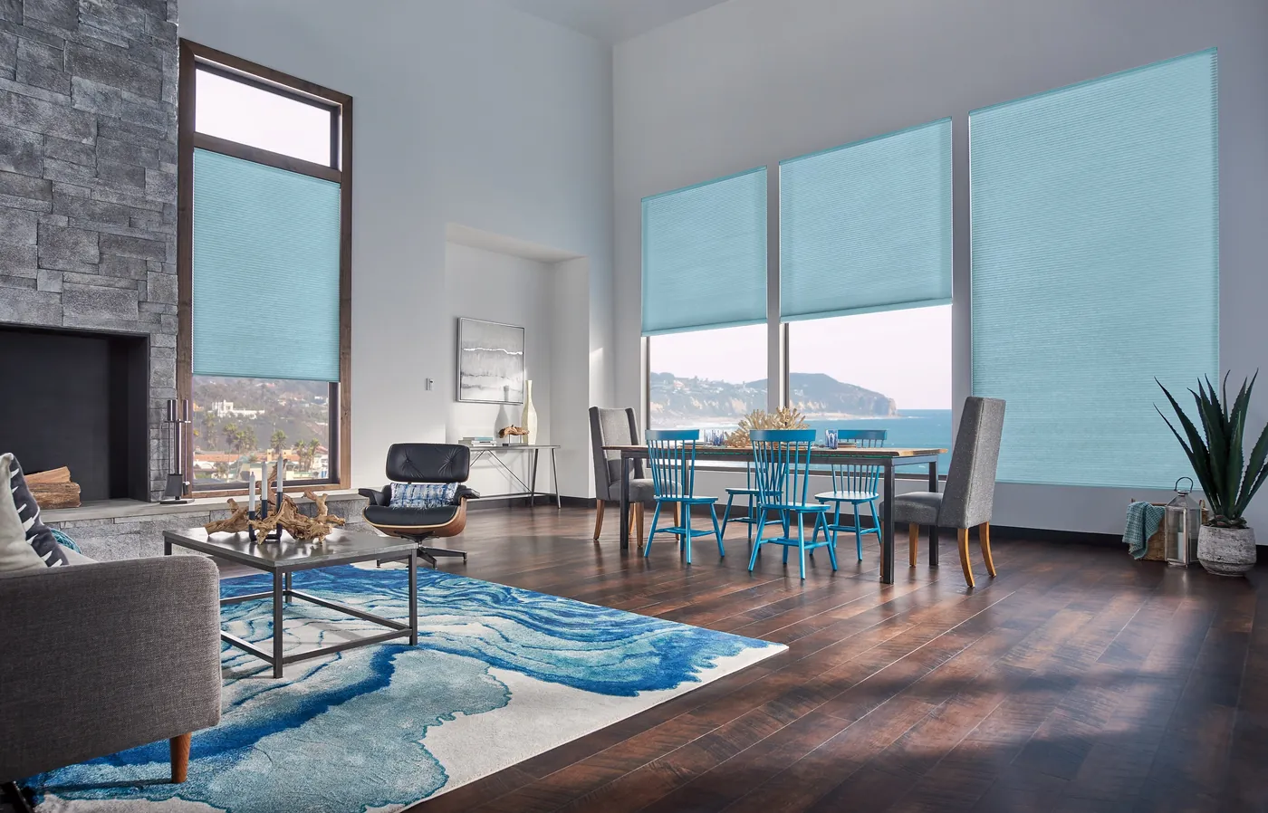 Light blue Graber cellular shades on tall living room windows